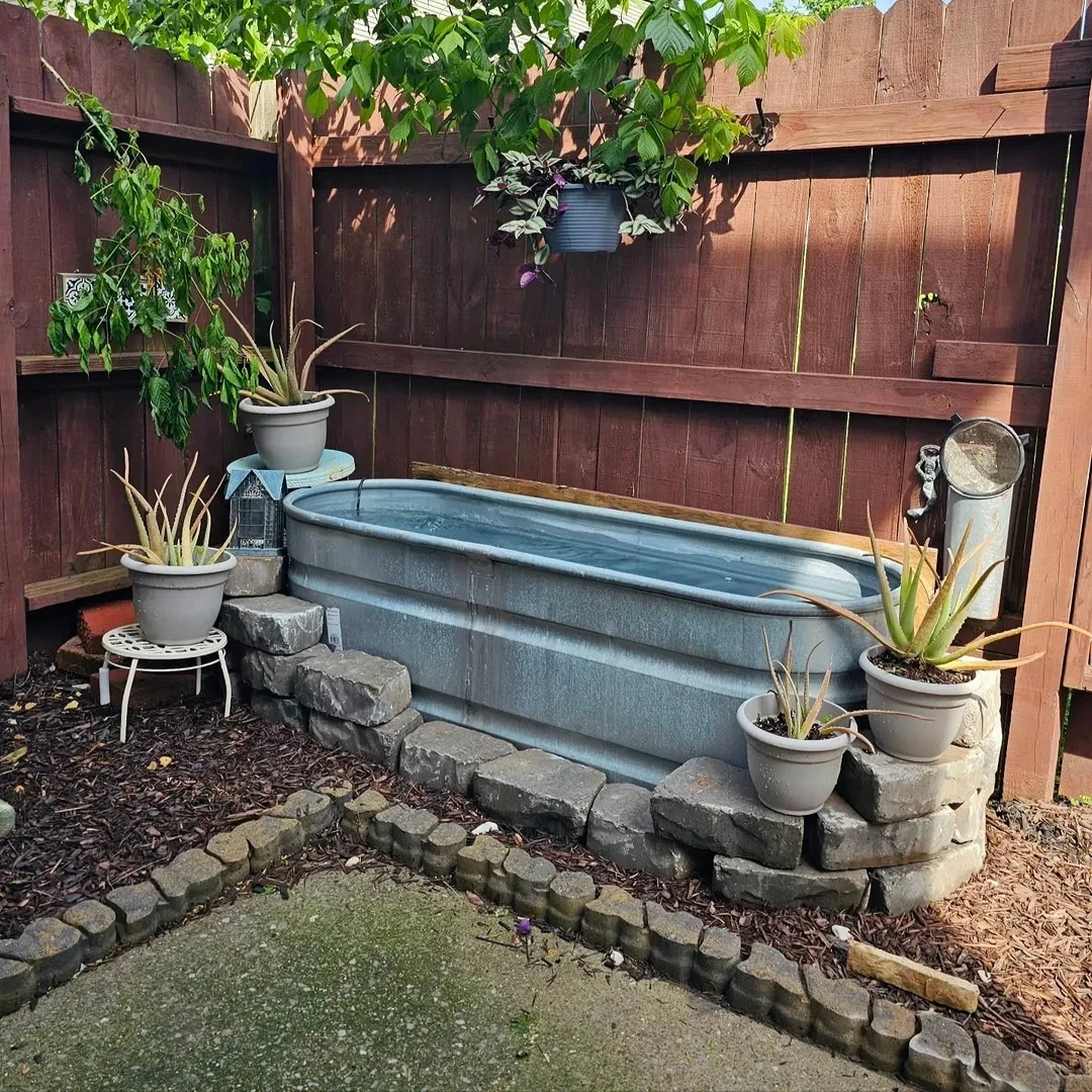 Fenced backyard and stock-tank soaking pool at 1821 Lincoya Bay Dr